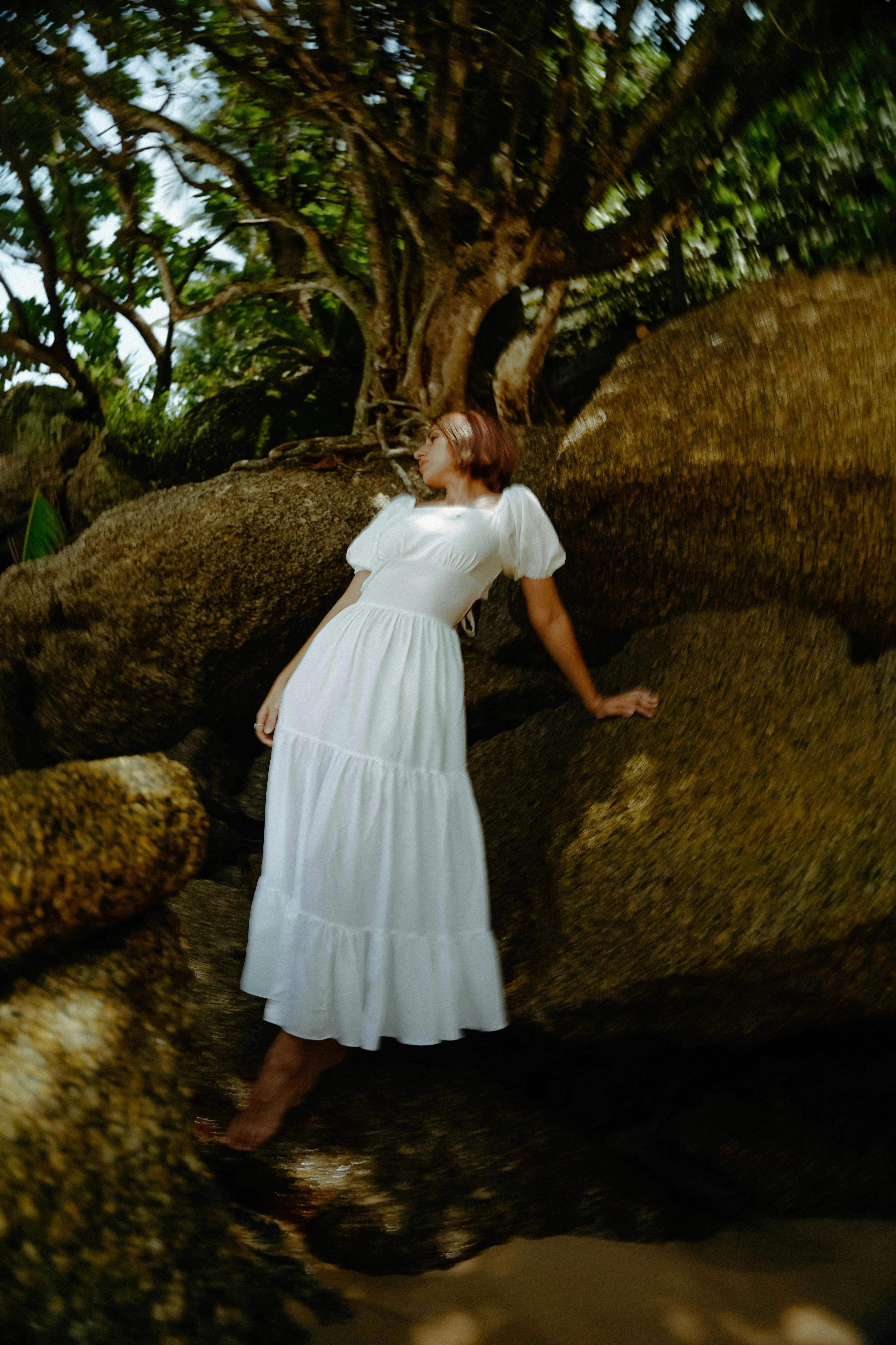 "Woman in a flowing white summer dress against a aesthetic background